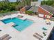 A high angle captures the blue community pool and lounge chairs surrounded by lush landscaping at 9100 Dr Martin Luther King Jr N St # 314, St Petersburg, FL 33702