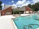 Close view of the community pool with fountain and chairs, nestled among lush greenery and landscaping at 9100 Dr Martin Luther King Jr N St # 314, St Petersburg, FL 33702