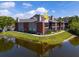 Apartment building overlooking a serene pond with well-maintained landscaping and inviting outdoor spaces at 9100 Dr Martin Luther King Jr N St # 314, St Petersburg, FL 33702