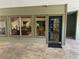 Charming patio with a textured tile surface, large windows showcasing the interior, and a teal entry door at 9100 Dr Martin Luther King Jr N St # 314, St Petersburg, FL 33702