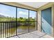 Patio with screened enclosure and view of lake and trees at 9100 Dr Martin Luther King Jr N St # 314, St Petersburg, FL 33702