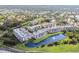 An aerial view shows the residential buildings with scenic landscaping and a water feature at 960 Starkey Rd # 7202, Largo, FL 33771