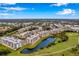 Wide angle aerial view of the real estate property showing golf course, pond and apartment complex at 960 Starkey Rd # 7202, Largo, FL 33771