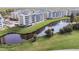 Aerial view of condos overlooking a peaceful pond and manicured grounds at 960 Starkey Rd # 7202, Largo, FL 33771