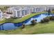 Aerial view of a condo community surrounding a pond with a fountain and well-manicured landscaping at 960 Starkey Rd # 7202, Largo, FL 33771