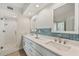 This bathroom features dual sinks, decorative mirrors, and modern lighting at 960 Starkey Rd # 7202, Largo, FL 33771