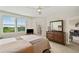 This bedroom features wood floors, a ceiling fan, a TV, and a door leading to the exterior at 960 Starkey Rd # 7202, Largo, FL 33771