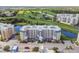 An exterior view of a modern residential building near a golf course and a water feature at 960 Starkey Rd # 7202, Largo, FL 33771