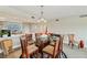 Open-concept dining room with glass table, six chairs, and bright lighting at 960 Starkey Rd # 7202, Largo, FL 33771