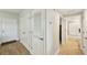 Hallway with wood-look floors, closet, and bathroom access at 960 Starkey Rd # 7202, Largo, FL 33771