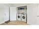 Laundry room with front load washer and dryer, shelving, and storage space at 960 Starkey Rd # 7202, Largo, FL 33771