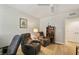 Living room area with two comfortable reclining chairs, shelving unit, and ceiling fan at 960 Starkey Rd # 7202, Largo, FL 33771