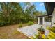 This backyard features a tiled patio, lush lawn, and attractive landscaping at 1047 Deer Hollow Way, Sarasota, FL 34232