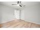 Bright, empty bedroom boasts light wood flooring, a ceiling fan, and a closet at 1047 Deer Hollow Way, Sarasota, FL 34232