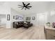 Comfortable living room with hardwood floors, a ceiling fan, and a view of the front entry at 1047 Deer Hollow Way, Sarasota, FL 34232