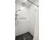 Modern shower showcasing sleek fixtures, stone floor and a built-in niche at 1047 Deer Hollow Way, Sarasota, FL 34232