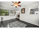 Sunroom with black tile floors and a view of the kitchen through an interior window at 1047 Deer Hollow Way, Sarasota, FL 34232