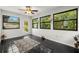 Bright sunroom featuring multiple windows, ceramic tile floors and a view of the backyard at 1047 Deer Hollow Way, Sarasota, FL 34232