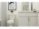 Bright bathroom featuring white vanity, granite countertop, framed art, and shower with curtain at 10825 Fort White Ct, Tampa, FL 33647