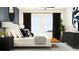 Stylish main bedroom with modern furnishings, including a bed, nightstands, and a decorative bench at 10825 Fort White Ct, Tampa, FL 33647