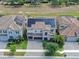 An aerial view showcases solar panels, landscaping, and paved driveway at 11227 Hawks Fern Dr, Riverview, FL 33569
