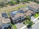 Aerial view of a home with solar panels, tile roof, pool, and well-manicured backyard at 11227 Hawks Fern Dr, Riverview, FL 33569