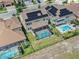An aerial view of home with a large screened in pool and solar panels on roof at 11227 Hawks Fern Dr, Riverview, FL 33569
