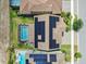 An aerial view showing homes with solar panels on roof and large screened in pool at 11227 Hawks Fern Dr, Riverview, FL 33569