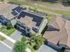 An aerial view of home showing solar panels, lush landscaping, and paved driveway at 11227 Hawks Fern Dr, Riverview, FL 33569