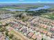 An aerial view showing the neighborhood with a lake in the background at 11227 Hawks Fern Dr, Riverview, FL 33569