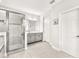 Bright bathroom with a glass-enclosed shower, tiled floors, and granite countertops at 11227 Hawks Fern Dr, Riverview, FL 33569