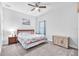 Cozy bedroom with a comfortable bed, ceiling fan, and beach-themed decor at 11227 Hawks Fern Dr, Riverview, FL 33569
