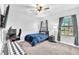 Bedroom featuring a cozy bed, black-out curtains, carpet floors, and gaming setup at 11227 Hawks Fern Dr, Riverview, FL 33569