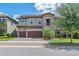 Charming two-story home with stone accents, three-car garage, and well-manicured landscaping at 11227 Hawks Fern Dr, Riverview, FL 33569