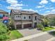 Charming two-story home showcasing a stone facade, lush landscaping, and a two-car garage at 11227 Hawks Fern Dr, Riverview, FL 33569