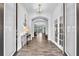 Inviting foyer with wood-look tile flooring, arched doorways, and stylish decor at 11227 Hawks Fern Dr, Riverview, FL 33569