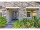 A stone-accented front porch with double doors and well-maintained landscaping at 11227 Hawks Fern Dr, Riverview, FL 33569