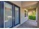 A close-up of the front door and entryway with stone pavers and covered porch at 11227 Hawks Fern Dr, Riverview, FL 33569