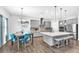 Open-concept kitchen with gray cabinetry, a breakfast bar, and an adjacent dining area at 11227 Hawks Fern Dr, Riverview, FL 33569