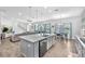 Open concept kitchen flows into the living area, dining area, and features a large island at 11227 Hawks Fern Dr, Riverview, FL 33569
