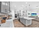 Open kitchen boasts stainless appliances, gray cabinetry, and a large center island at 11227 Hawks Fern Dr, Riverview, FL 33569