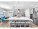 Bright kitchen featuring a large island with seating, pendant lights, and a dining area at 11227 Hawks Fern Dr, Riverview, FL 33569