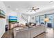 Relaxing living room with a large TV, comfortable seating, and backyard views at 11227 Hawks Fern Dr, Riverview, FL 33569