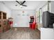 Spacious living room featuring wood-look tile flooring, ample natural light, and fun decor at 11227 Hawks Fern Dr, Riverview, FL 33569