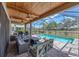 Screened patio with comfortable seating areas, a pool view, and a beautiful wood plank ceiling at 11227 Hawks Fern Dr, Riverview, FL 33569
