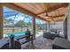 Screened-in patio featuring an outdoor kitchen, grill, and a clear view of the sparkling swimming pool at 11227 Hawks Fern Dr, Riverview, FL 33569