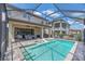 A relaxing pool area with lounge chairs, a covered patio, and a serene outdoor space at 11227 Hawks Fern Dr, Riverview, FL 33569