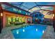 A refreshing swimming pool with sun loungers, outdoor dining, and a screened-in enclosure at 11227 Hawks Fern Dr, Riverview, FL 33569