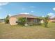 Enjoy the serene backyard featuring a screened lanai perfect for outdoor relaxation and entertainment at 12124 Colonial Estates Ln, Riverview, FL 33579