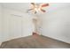 A light-filled bedroom includes a ceiling fan, neutral carpet, and closet providing a peaceful retreat at 12124 Colonial Estates Ln, Riverview, FL 33579